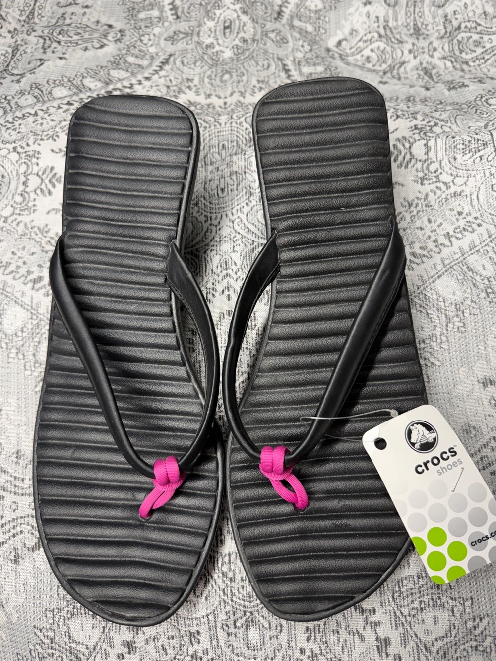 CROCS Women’s Black Flip Sandals with Pink Knot Accent - Size 10